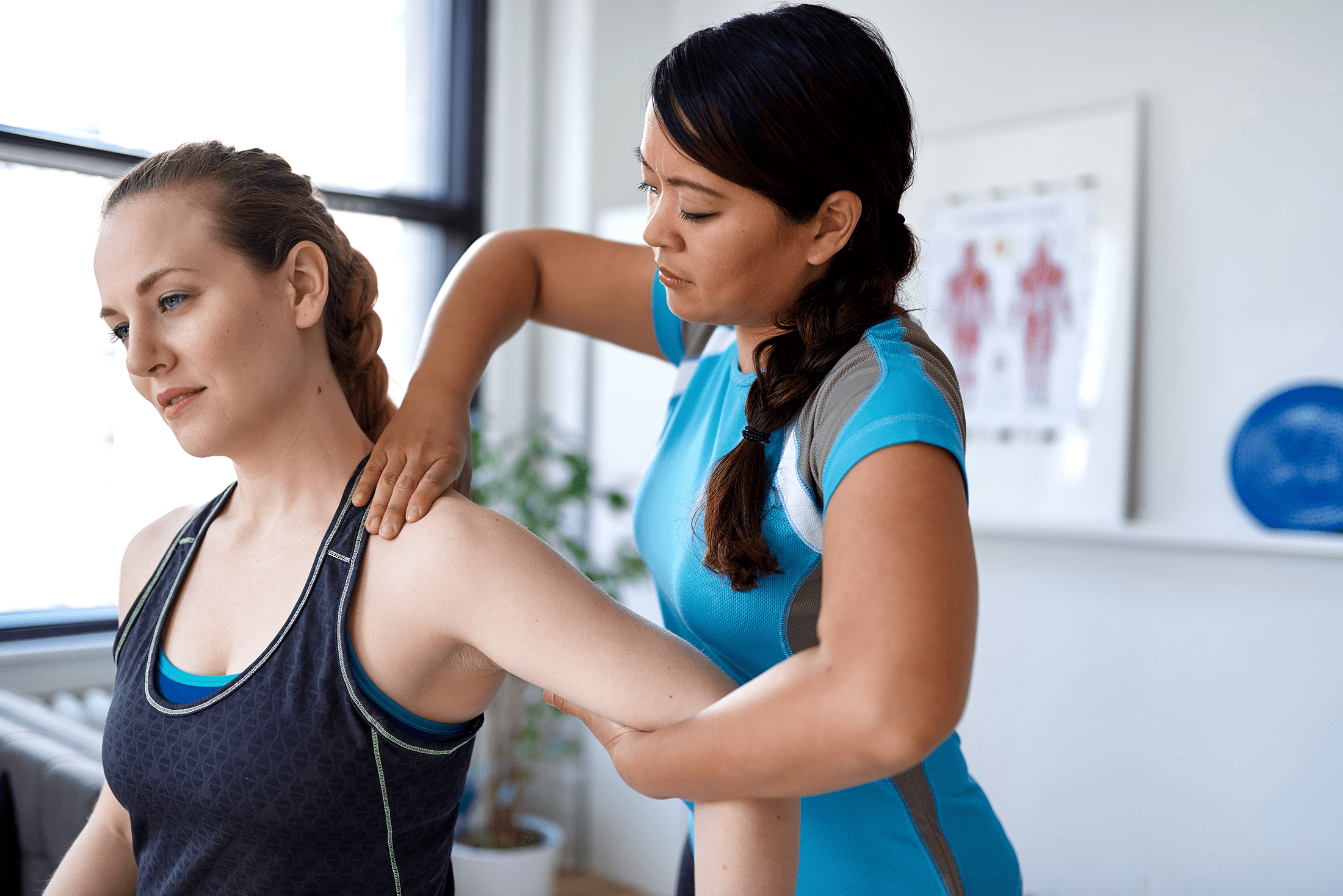 woman having chiropractic adjustment to her shoulder